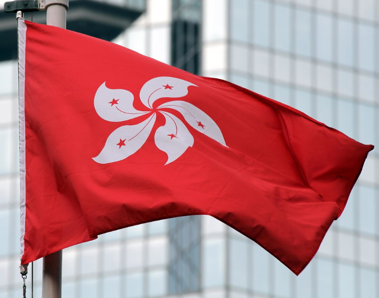 Hong Kong flag in front of skyscraper 